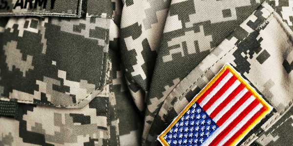 A close up of the american flag patch on a military uniform.