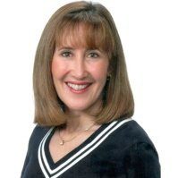 A woman with brown hair and wearing a black shirt.